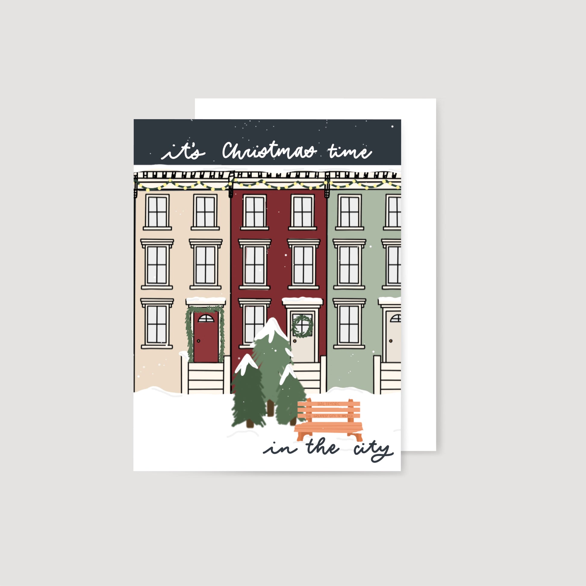 Card with a festive illustration of a snowy street scene and text 'it's Christmas time in the city'.